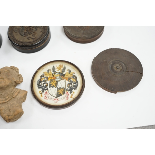 502 - A carved wood case containing armorial crest, Tenax Justitiae, four other circular boxes and a porta... 