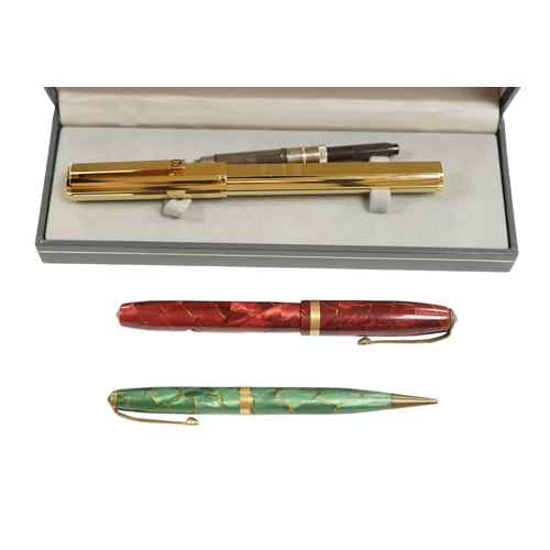 503 - A cased Dunhill gold plated fountain pen and two other pens, Dunhill pen 13.5cm long. Condition - fa... 