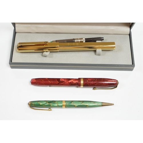 503 - A cased Dunhill gold plated fountain pen and two other pens, Dunhill pen 13.5cm long. Condition - fa... 