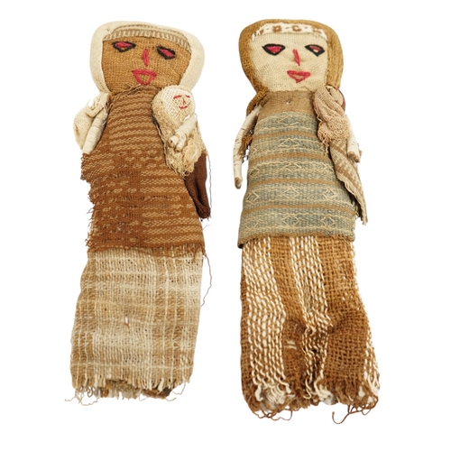 506 - Two antique Chancay culture, central Peruvian hand made fabric dolls each carrying a baby. 25cm high... 