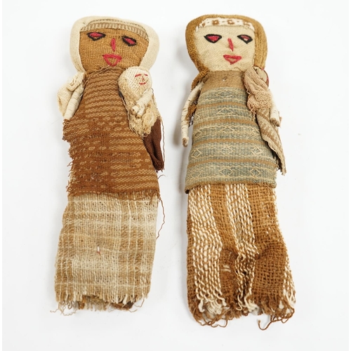 506 - Two antique Chancay culture, central Peruvian hand made fabric dolls each carrying a baby. 25cm high... 