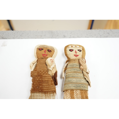 506 - Two antique Chancay culture, central Peruvian hand made fabric dolls each carrying a baby. 25cm high... 