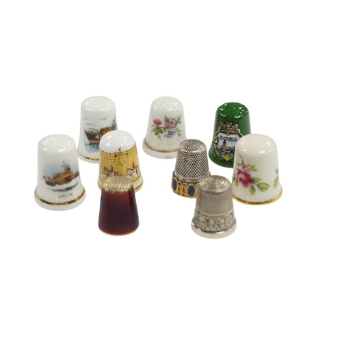 507 - A large collection of silver, nickel, brass and ceramic thimbles, and two thimble display perspex do... 