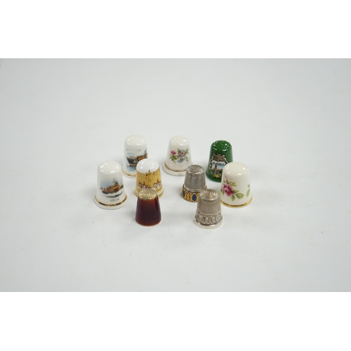 507 - A large collection of silver, nickel, brass and ceramic thimbles, and two thimble display perspex do... 