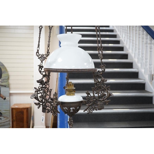 553 - A French barn iron and white glass hanging lamp, approximately 140cm high. Condition - used, iron wo... 