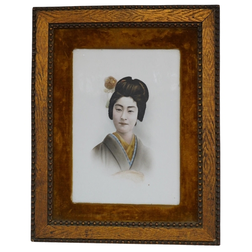 556 - A framed Japanese painted porcelain plaque of a Geisha, 24cm wide, 33cm high. Condition - fair... 