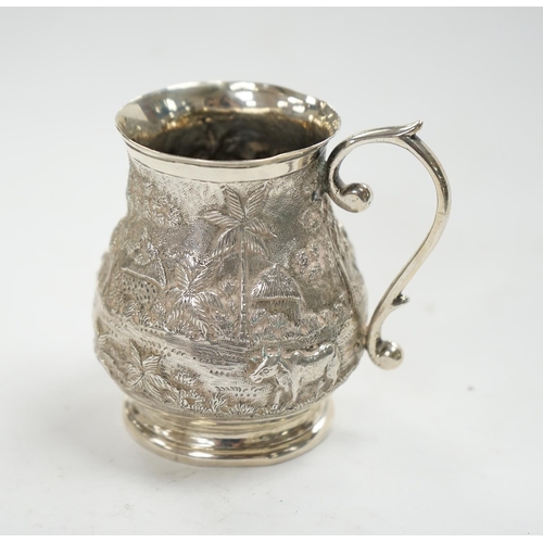 827 - An Indian embossed white metal baluster mug, height 77mm, 94 grams. Condition - poor to fair