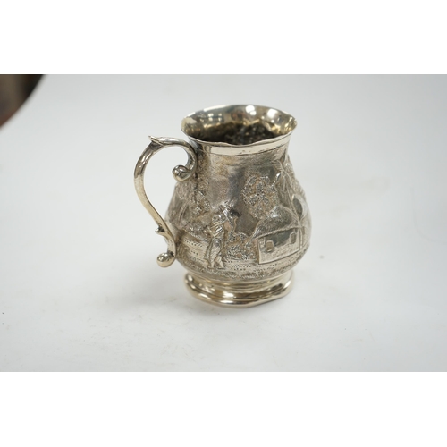 827 - An Indian embossed white metal baluster mug, height 77mm, 94 grams. Condition - poor to fair