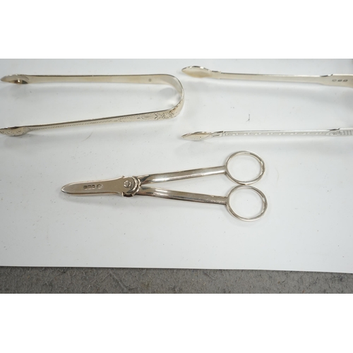 835 - A pair of George V silver grape scissors, by William Hutton & Sons, two pairs of silver sugar tongs ... 