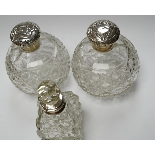 839 - A pair of silver mounted cut glass scent bottles, marks rubbed, 12.3cm and one other silver mounted ... 