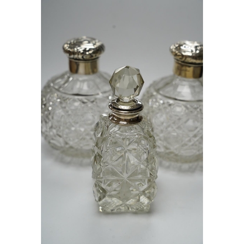 839 - A pair of silver mounted cut glass scent bottles, marks rubbed, 12.3cm and one other silver mounted ... 