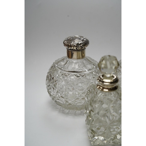 839 - A pair of silver mounted cut glass scent bottles, marks rubbed, 12.3cm and one other silver mounted ... 