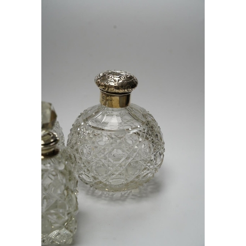 839 - A pair of silver mounted cut glass scent bottles, marks rubbed, 12.3cm and one other silver mounted ... 