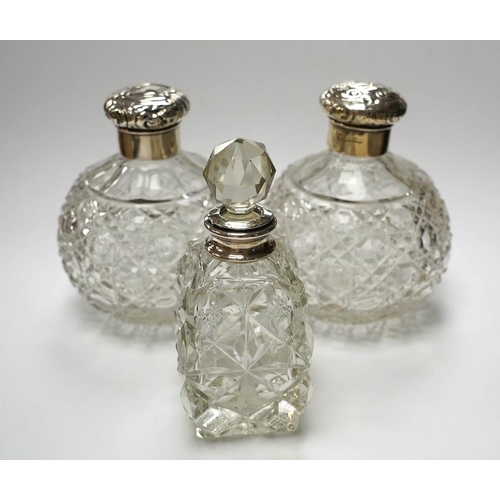 839 - A pair of silver mounted cut glass scent bottles, marks rubbed, 12.3cm and one other silver mounted ... 