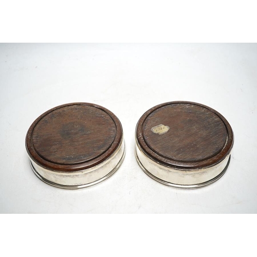 843 - A pair of 19th century Continental white metal wine coasters, inset with turned mahogany bases, 12.5... 