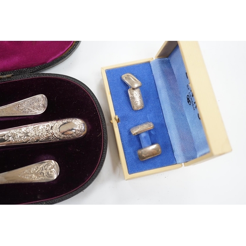 854 - A late Victorian cased chased silver christening trio, London, 1897/90, together with a pair of engr... 