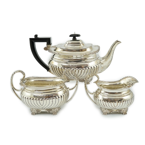 855 - A late Victorian demi fluted silver three piece tea set, by The Barnards, of oval form, with engrave... 