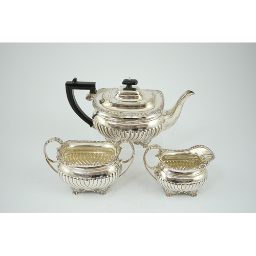 855 - A late Victorian demi fluted silver three piece tea set, by The Barnards, of oval form, with engrave... 