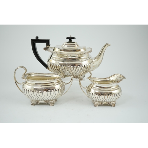 855 - A late Victorian demi fluted silver three piece tea set, by The Barnards, of oval form, with engrave... 