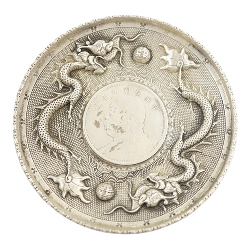 882 - A Chinese white metal dish inset with Yuan Shikai coin, 10.1cm. Condition - fair