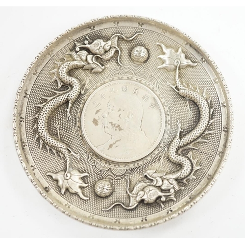 882 - A Chinese white metal dish inset with Yuan Shikai coin, 10.1cm. Condition - fair