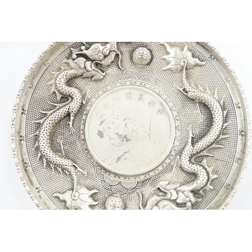 882 - A Chinese white metal dish inset with Yuan Shikai coin, 10.1cm. Condition - fair