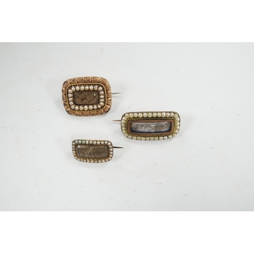 908 - Three assorted 19th century yellow metal and seed pearl set mourning brooches, two with plaited hair... 