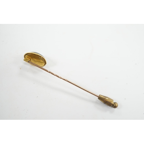 912 - A cased Victorian yellow metal, oval cabochon garnet and diamond chip set stick pin, overall 77mm. C... 