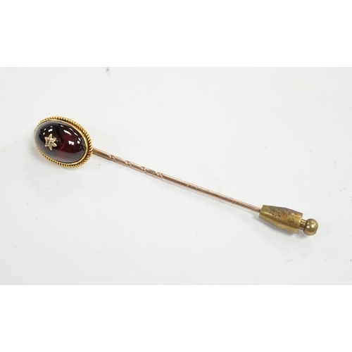 912 - A cased Victorian yellow metal, oval cabochon garnet and diamond chip set stick pin, overall 77mm. C... 