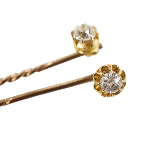 953 - Two early 20th century yellow metal and solitaire diamond set stick pins, 65mm and a dress stud. Con... 