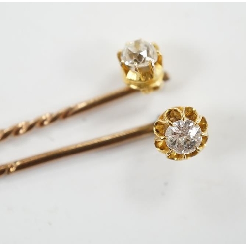 953 - Two early 20th century yellow metal and solitaire diamond set stick pins, 65mm and a dress stud. Con... 