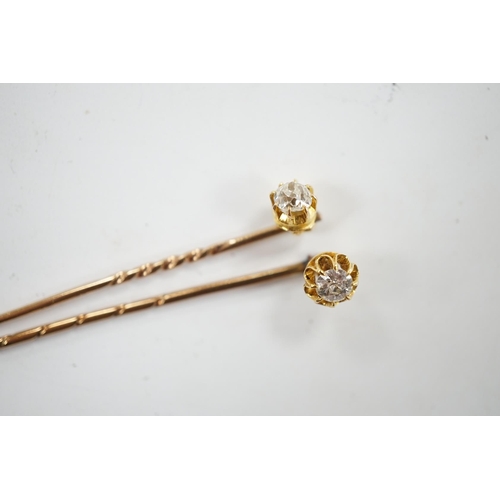 953 - Two early 20th century yellow metal and solitaire diamond set stick pins, 65mm and a dress stud. Con... 