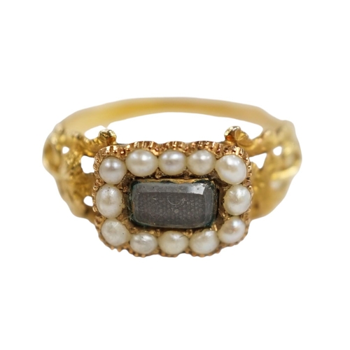 957 - A 19th century yellow metal, seed pearl and plaited hair set mourning ring, the ring head verso insc... 