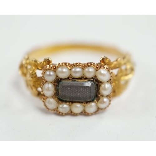 957 - A 19th century yellow metal, seed pearl and plaited hair set mourning ring, the ring head verso insc... 