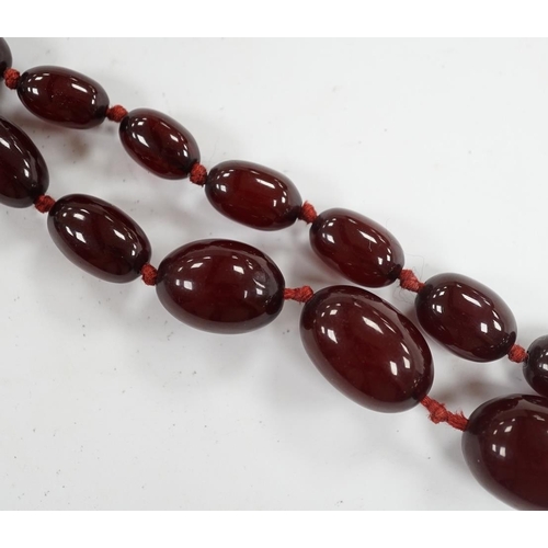 976 - A single strand graduated simulated cherry amber bead necklace, gross weight 66 grams (string a.f.) ... 