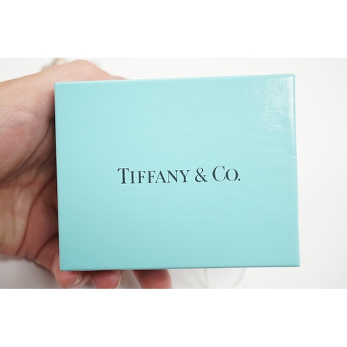 989 - A group of Tiffany & Co sterling novelties; a pair of Frank Gehry Morph cufflinks, a toothpaste wind... 