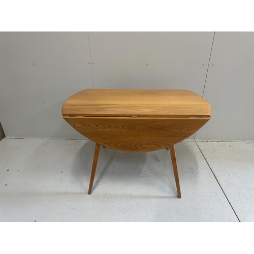 1027 - An Ercol elm oval drop leaf dining table, width 124cm extended, height 71cm, together with five Erco... 