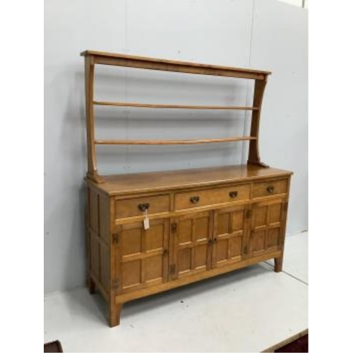 1029 - Alan Grainger 'Acorn Man', a mid century adzed oak dresser with open plate rack, width 160cm, depth ... 