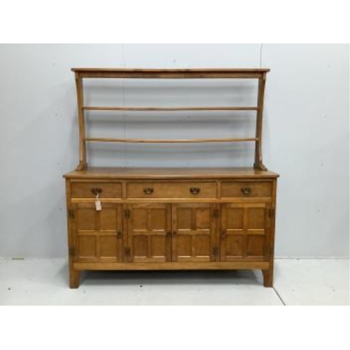 1029 - Alan Grainger 'Acorn Man', a mid century adzed oak dresser with open plate rack, width 160cm, depth ... 