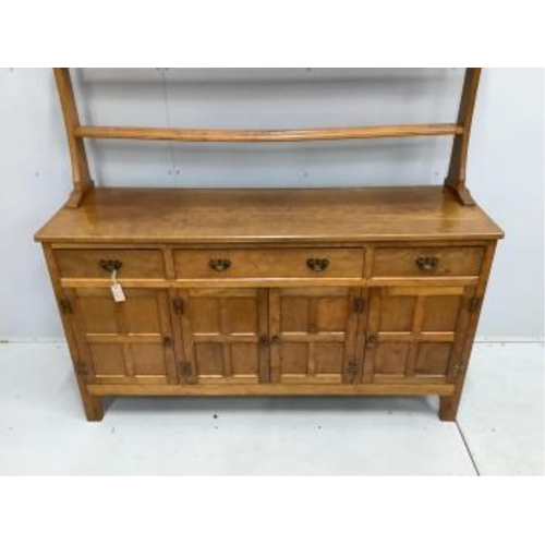 1029 - Alan Grainger 'Acorn Man', a mid century adzed oak dresser with open plate rack, width 160cm, depth ... 