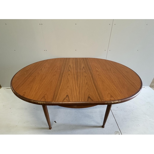 1058 - A G Plan circular teak extending dining table, diameter 120cm, height 74cm, and six chairs. Conditio... 