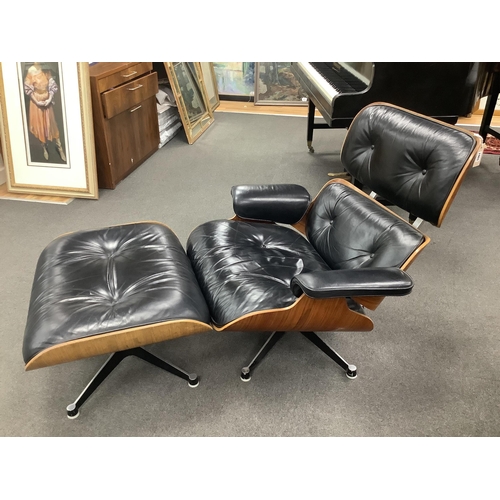 1061 - Charles and Ray Eames, a model 670 black leather and Indian rosewood lounge chair, width 85cm, depth... 