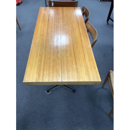 1063 - In the manner of Charlotte Perriand, a mid century rectangular maple dining table on twin three pron... 