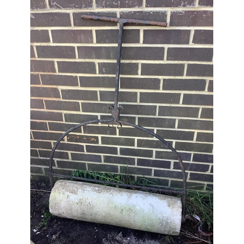 1182 - A wrought iron and reconstituted stone garden roller, height 116cm. Condition - fair