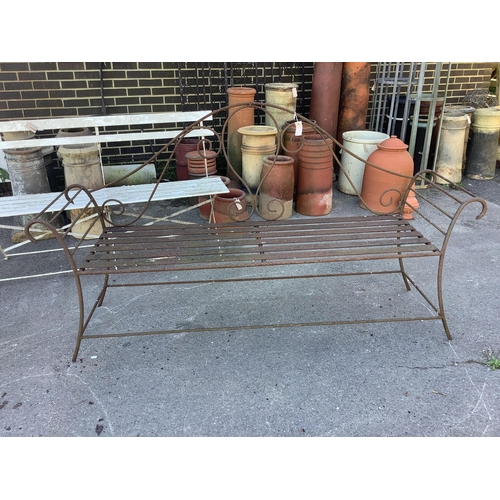 1208 - A pair of wrought iron garden benches, width 184cm, height 102cm. Condition - fair