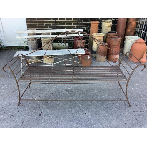 1208 - A pair of wrought iron garden benches, width 184cm, height 102cm. Condition - fair