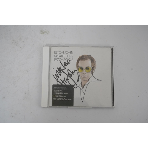 1350 - A signed Elton John CD; Greatest Hits 1970-2002, signed to the cover of the booklet in black ink, pu... 