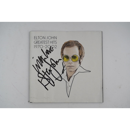 1350 - A signed Elton John CD; Greatest Hits 1970-2002, signed to the cover of the booklet in black ink, pu... 