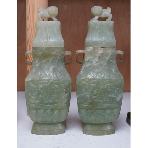 1405 - A pair of Chinese carved green quartz vases and covers, 21cm. Condition - fair, natural crack to bod... 