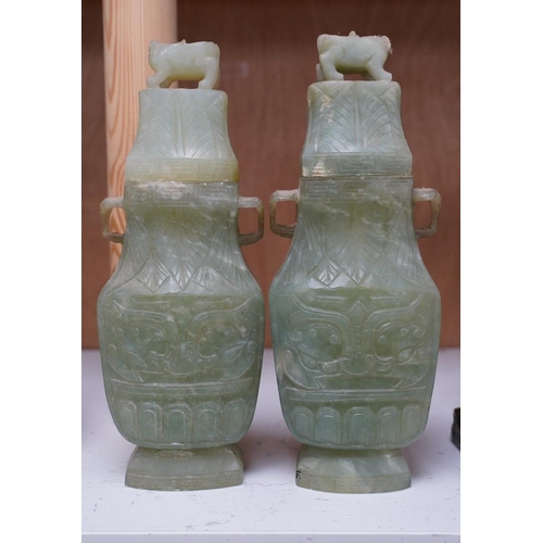 1405 - A pair of Chinese carved green quartz vases and covers, 21cm. Condition - fair, natural crack to bod... 